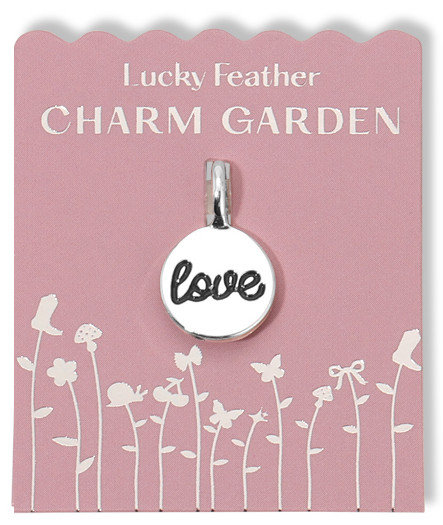 Love charm on a pink 'Lucky Feather Charm Garden' display card with flower graphics.