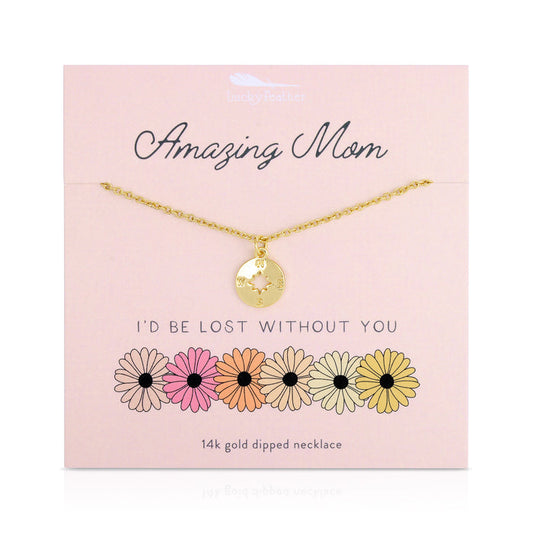 A gold compass necklace on a pink display card with the words 'Amazing Mom' and 'I'd Be Lost Without You'.