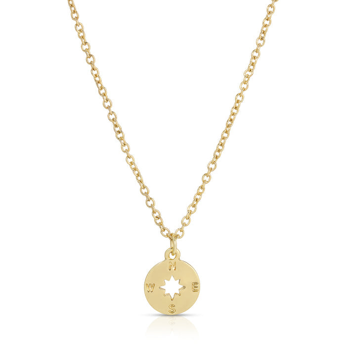 A gold chain necklace with a compass pendant is on a white background.