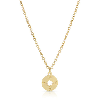 A gold chain necklace with a compass pendant is on a white background.
