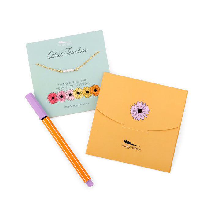 A 'Best Teacher' necklace gift set with an orange pen.