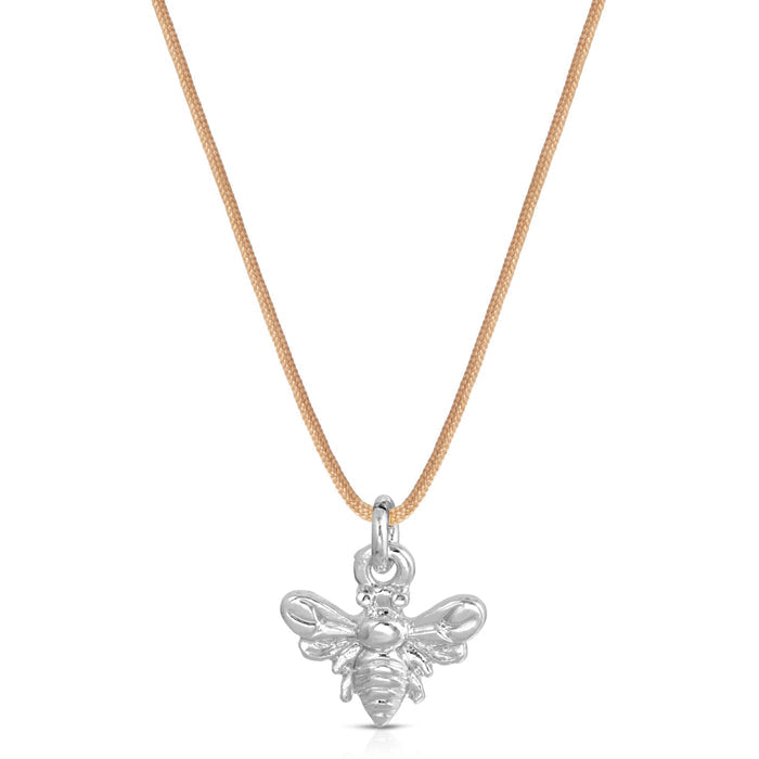 A necklace with a tan cord and a silver-colored bee pendant is centered on a white background.