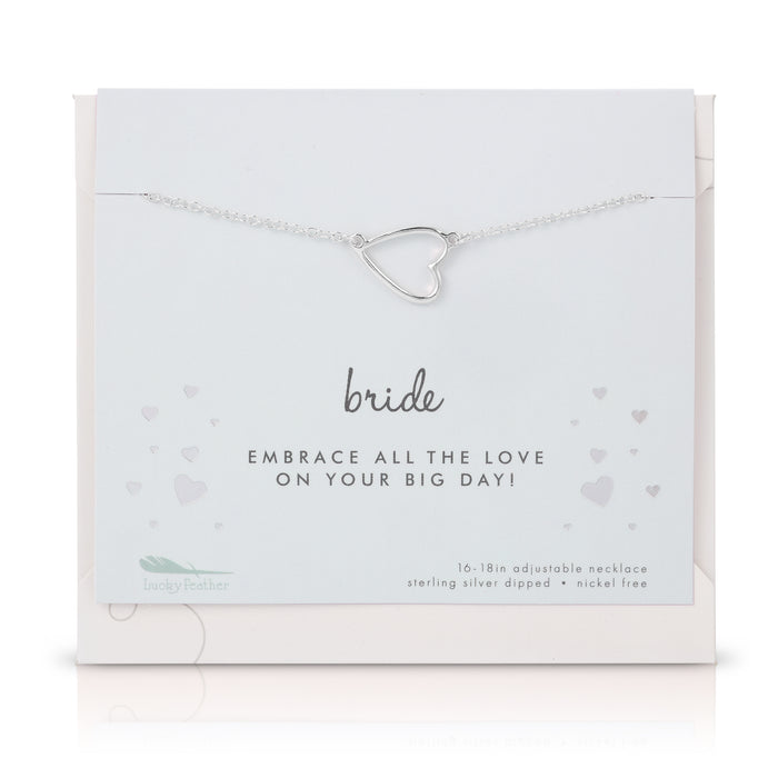A silver heart pendant necklace on a 'Bride' card from Lucky Feather.
