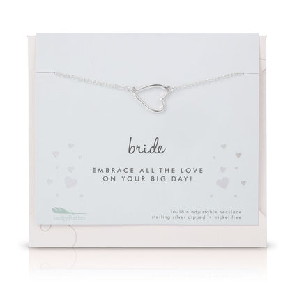 A silver heart pendant necklace on a 'Bride' card from Lucky Feather.