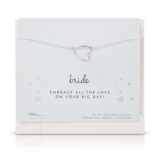 A silver heart pendant necklace on a 'Bride' card from Lucky Feather.