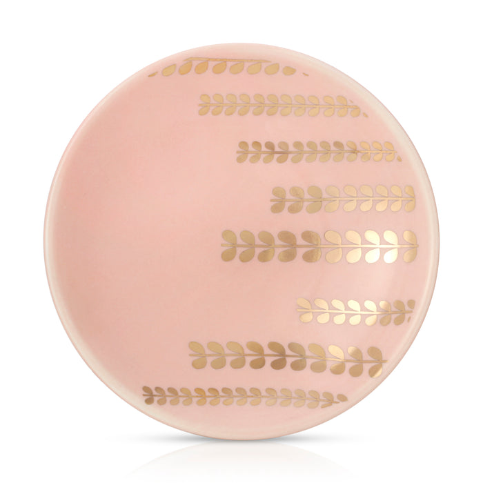 A pink plate is decorated with four horizontal lines of gold, leafy patterns.