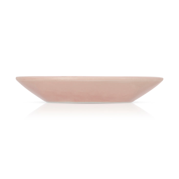 A light pink square ceramic plate is shown on a white surface.
