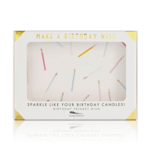 A white box with gold accents displays a trinket dish with a pattern of birthday candles, and the text 'MAKE A BIRTHDAY WISH' and 'SPARKLE LIKE YOUR BIRTHDAY CANDLES! BIRTHDAY TRINKET DISH.'