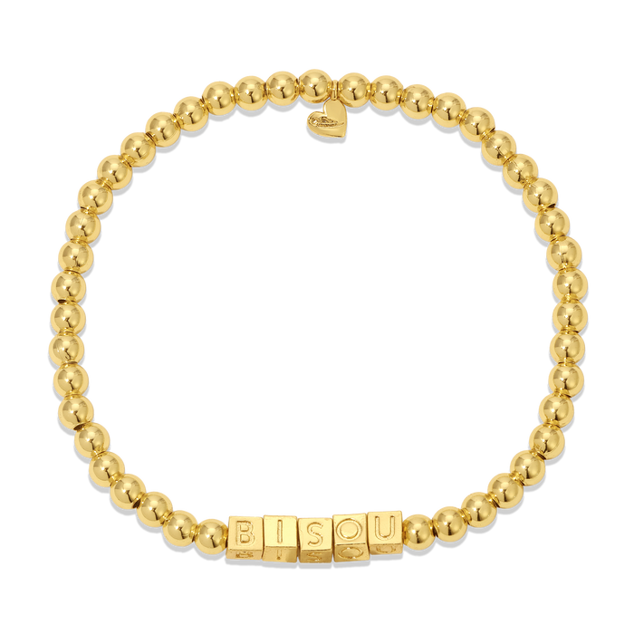 A gold beaded bracelet spells out 'BISOU' in block letters and features a heart charm.
