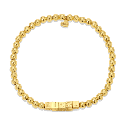 A gold beaded bracelet spells out 'BISOU' in block letters and features a heart charm.