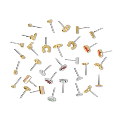 Assorted stud earrings are scattered on a white surface.
