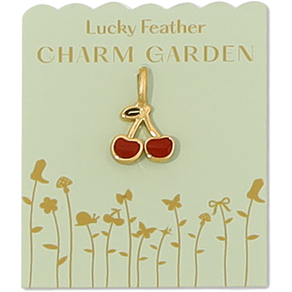 A gold cherry charm is centered on a light green 'Lucky Feather Charm Garden' display card.