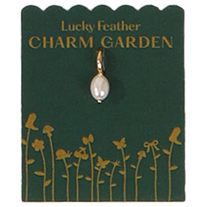 A pearl charm on a 'Lucky Feather Charm Garden' card with gold flower illustrations.