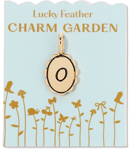 A gold-colored 'O' charm on a 'Lucky Feather Charm Garden' card with a pale blue background.