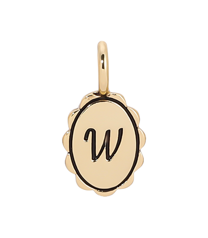 A gold charm with a scalloped edge features a cursive letter 'W.'