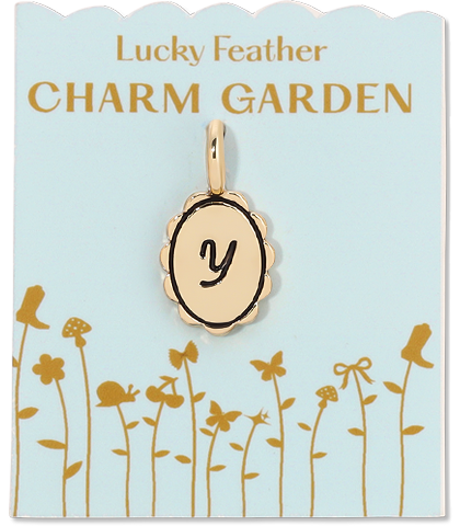 A gold charm with the letter 'y' on a pale blue card labeled 'Lucky Feather Charm Garden'.