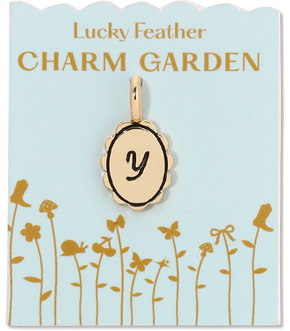 A gold charm with the letter 'y' on a pale blue card labeled 'Lucky Feather Charm Garden'.