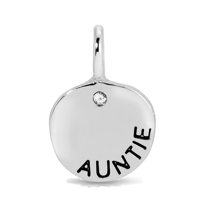 A silver pendant with the word 'AUNTIE' inscribed on it and a small clear gem.