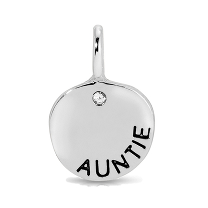 A silver pendant with the word 'AUNTIE' inscribed on it and a small clear gem.