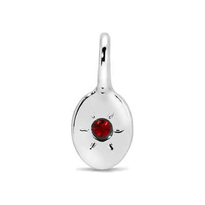 A silver pendant with a red stone in the center.