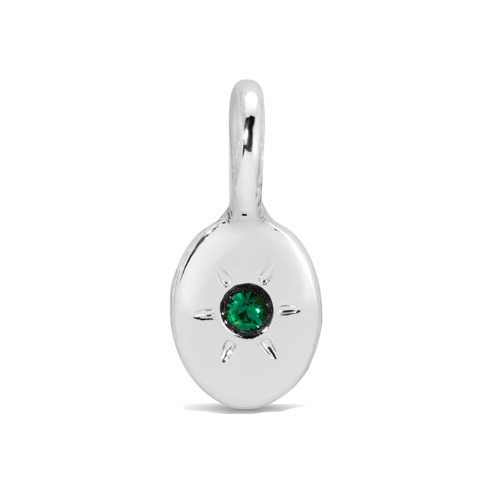 Close-up of a silver pendant with a green gem.