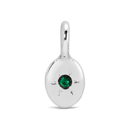 Close-up of a silver pendant with a green gem.