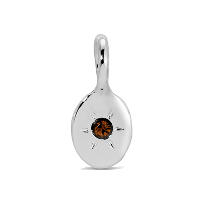 A silver charm with a brown jewel-like stone in the center is displayed.