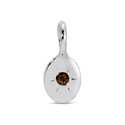 A silver charm with a brown jewel-like stone in the center is displayed.