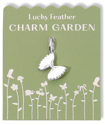 A silver butterfly charm on a green card with white garden-themed graphics and the words 'Lucky Feather CHARM GARDEN'.