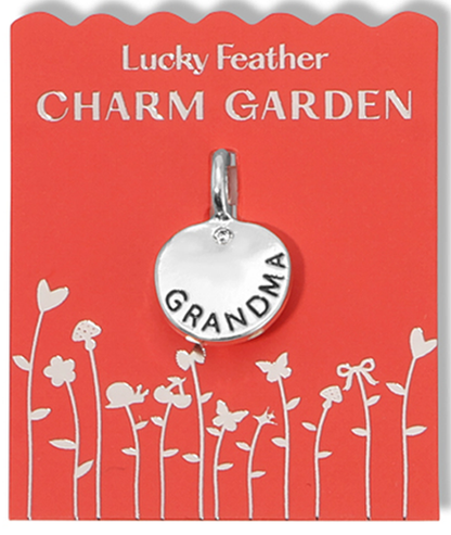 A 'Lucky Feather Charm Garden' tag holds a silver 'Grandma' pendant.
