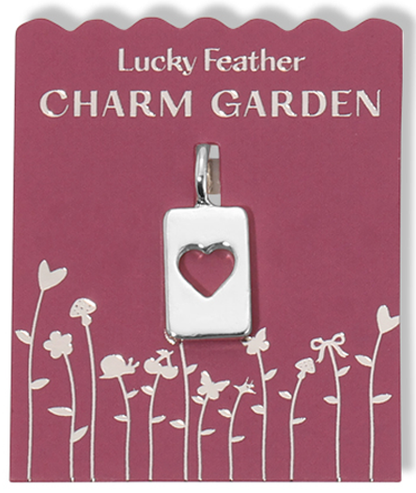 A silver heart charm pendant on a pink 'Lucky Feather Charm Garden' card with floral designs.