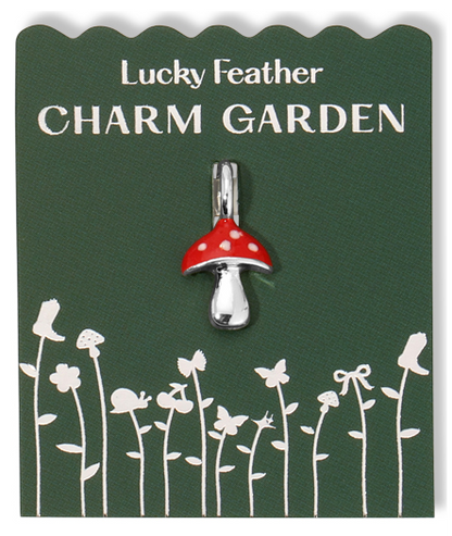 A mushroom charm on a green card labeled 'Lucky Feather CHARM GARDEN.'