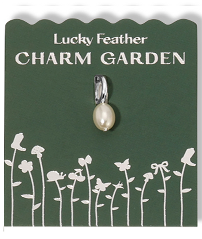 Lucky Feather Charm Garden tag displays a pearl charm with a silver bail and white garden-themed imagery on a green background.