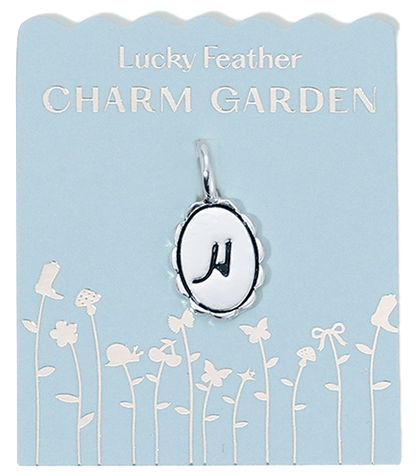 Lucky Feather Charm Garden card featuring a silver charm with the letter 'H' on a light blue background with a floral design.