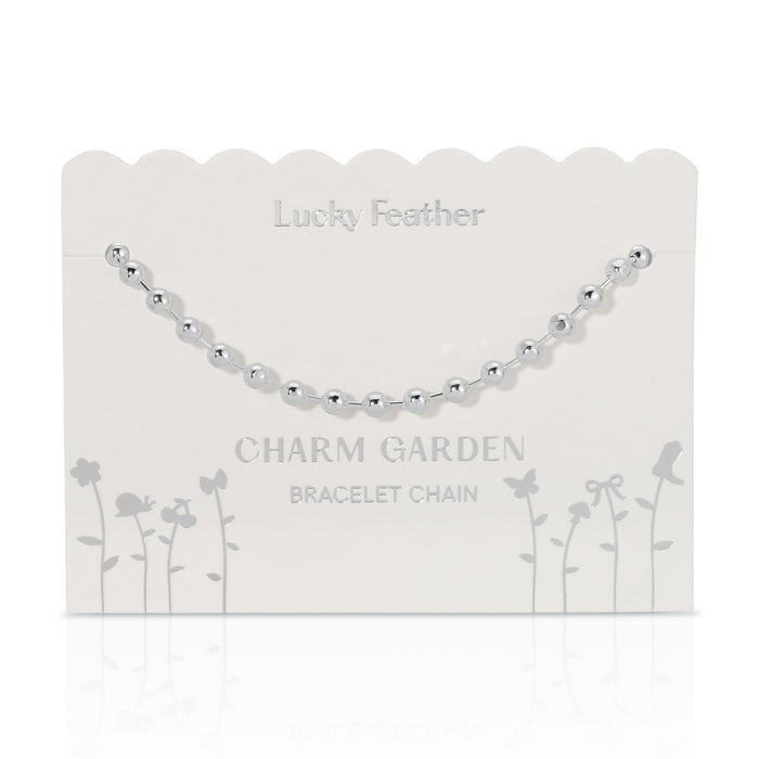 Silver beaded bracelet chain on a 'Lucky Feather Charm Garden' display card.