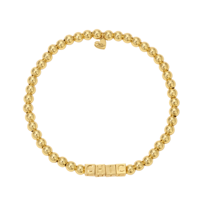 A bracelet composed of gold-colored beads spells the word 'CHIC' and has a heart charm.