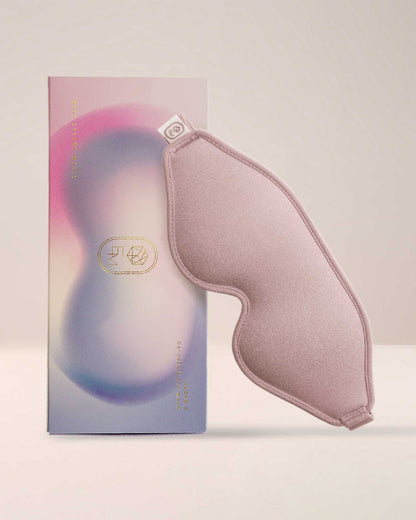The elegant packaging for the EM Cosmetics Cloud 9 Daydream Eye Mask, a luxurious silk mask for restful sleep.
