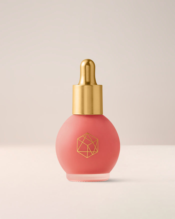 EM Cosmetics Color Drops Serum Blush in Pink Nectar, a watermelon pink, shown closed in its glass dropper bottle.
