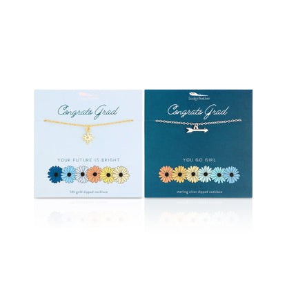 Two graduation-themed necklaces with star and arrow charms on cards, one gold and one silver.