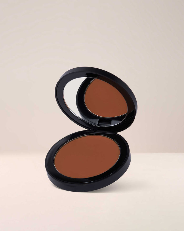 EM Cosmetics Corselette Powder Bronzer in Sultry, a medium shade that adds natural-looking definition and warmth.