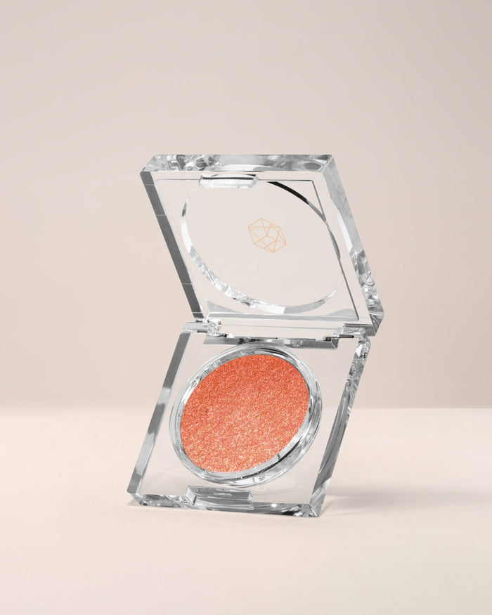 EM Cosmetics Cosmic Pearl Dewy Eyeshadow in Helios, a warm bronze with a high-shine, dewy metallic finish.