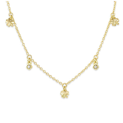 A gold chain necklace features clover and square charms.