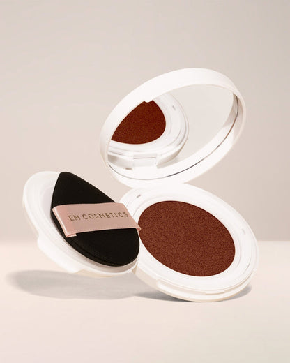 EM Cosmetics Daydream Cushion Foundation with SPF in Magic Dream, a rich shade for a deep, even, and glowing complexion.