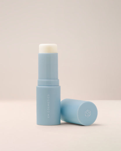 EM Cosmetics Face Cuddle Moisture Balm, a solid moisturizing stick shown open to reveal its clear, hydrating formula.