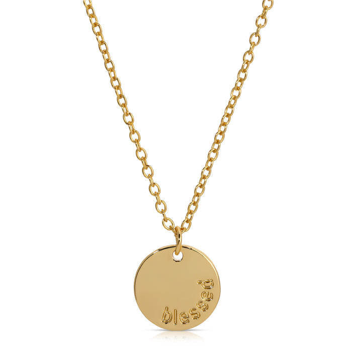 A gold necklace with a circular pendant is displayed against a white background.