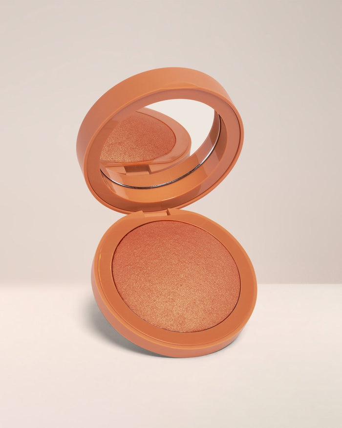 EM Cosmetics Heaven's Glow Blush in Faded Clementine, a soft tangerine shade for a warm, sun-kissed radiant finish.