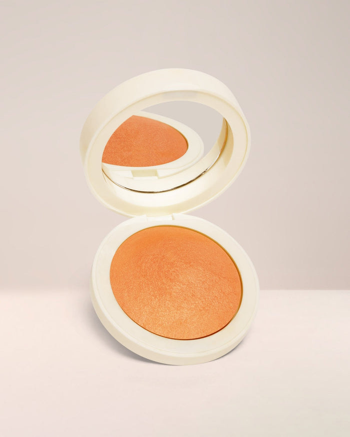 EM Cosmetics Heaven's Glow Blush in Persimmon, a soft orange nude that provides a natural, radiant warmth to the cheeks.
