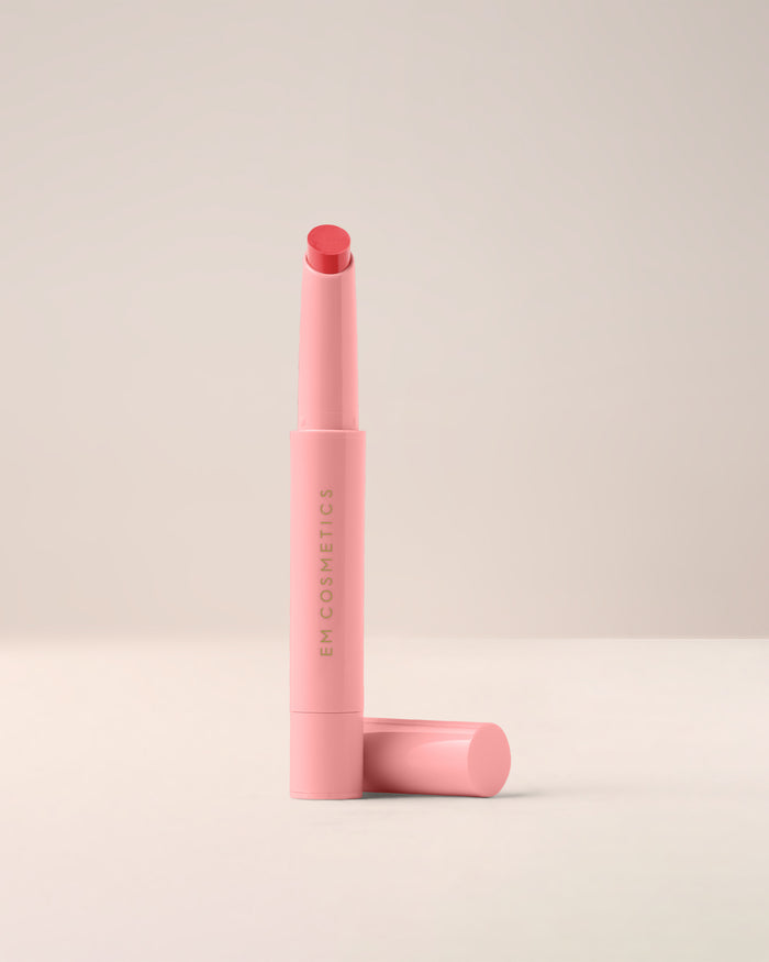 EM Cosmetics Lip Cushion in Angèle, a warm nude, shown open to reveal its nourishing, high-shine tinted lip luminizer.
