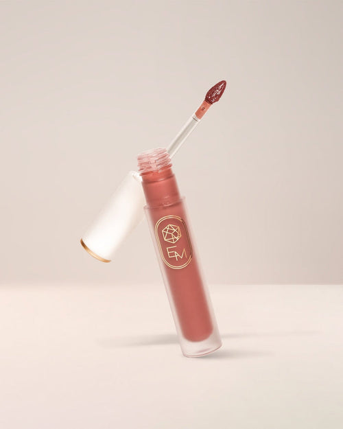 EM Cosmetics Lip Mage Tinted Serum in Ember, a warm terracotta shade with a hydrating, satin-matte, blotted finish.