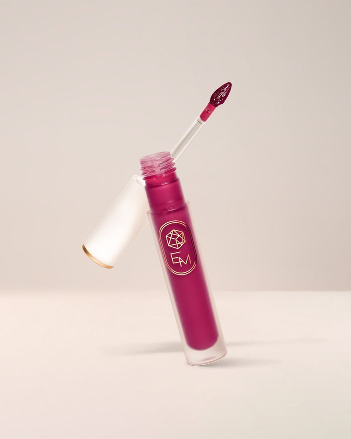 EM Cosmetics Lip Mage Tinted Serum in Charmed, a rosy pink, a comfortable lip stain with a serum-like texture.